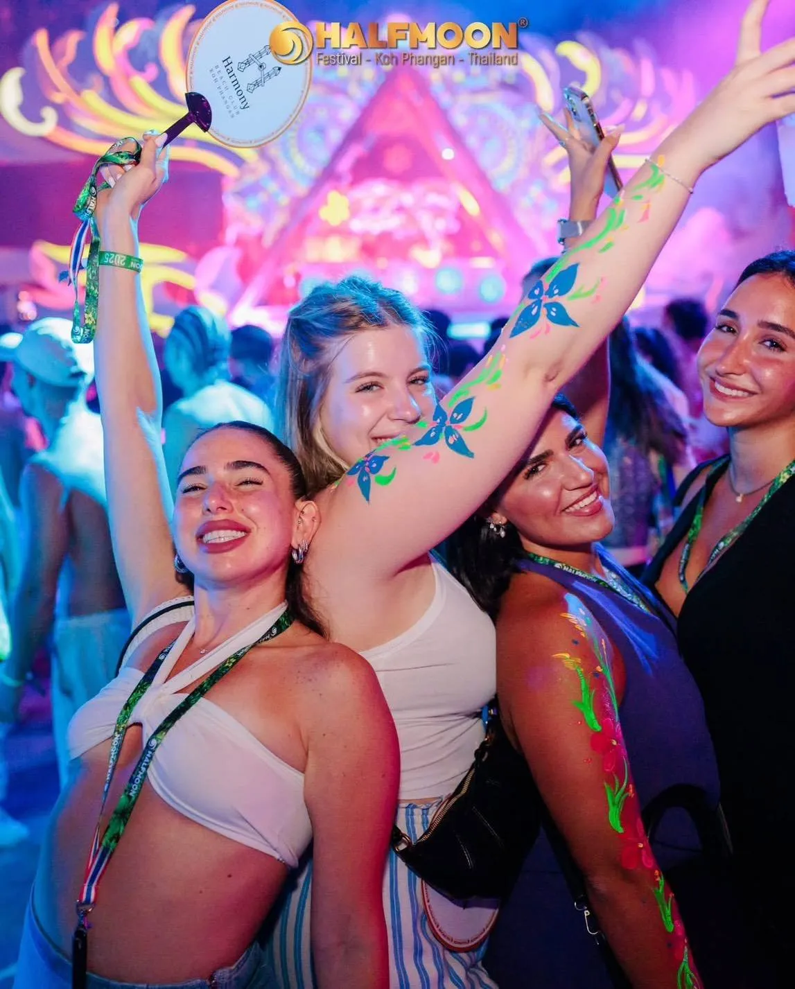 Halfmoon Party Koh Phangan – four friends smiling with glowing body paint at the festival