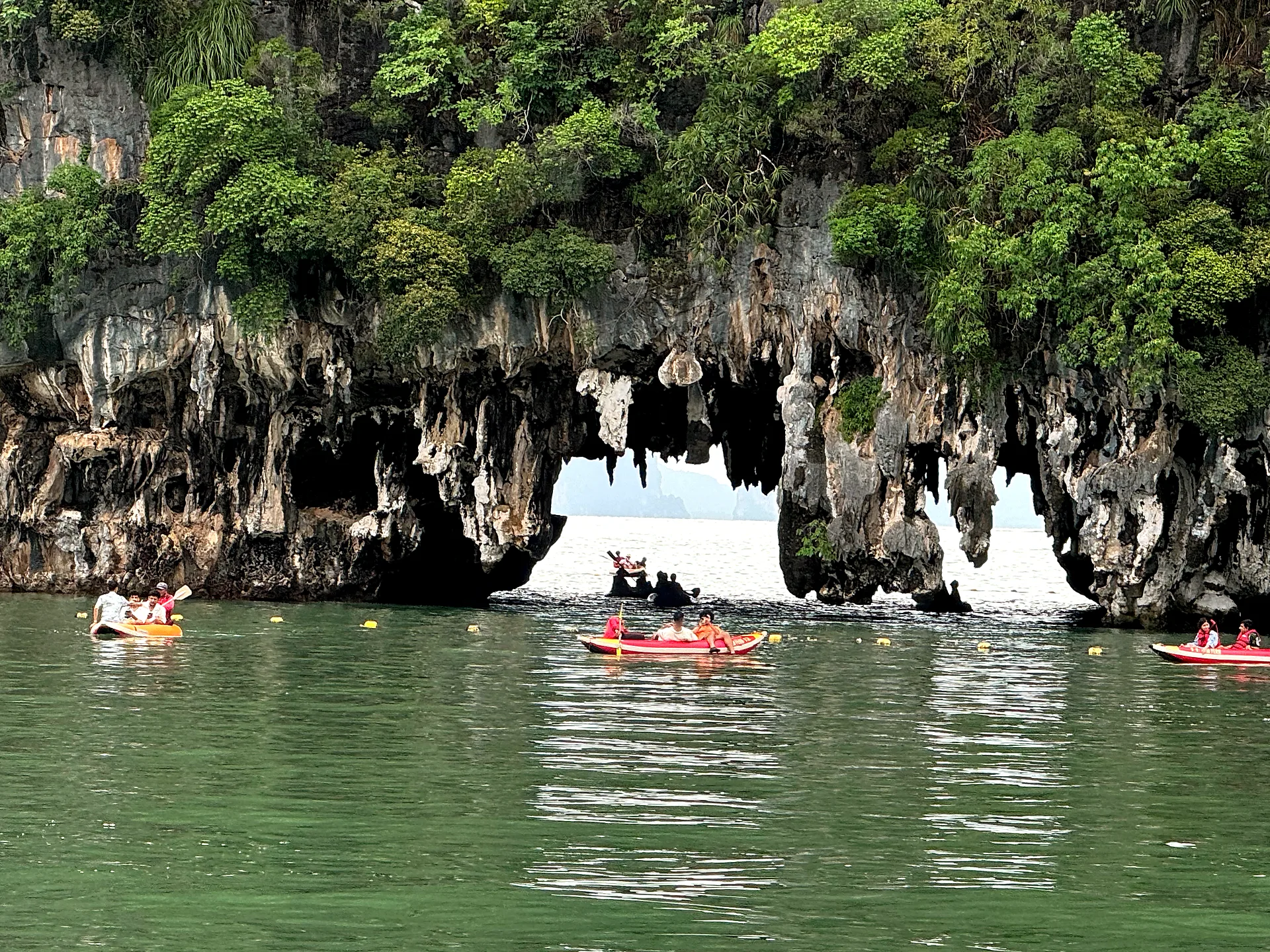 Limestone arch and sea kayaks in Phang Nga Bay