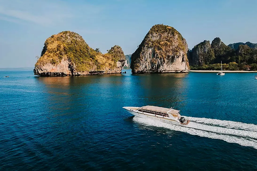 Two limestone islands rising from the calm blue sea