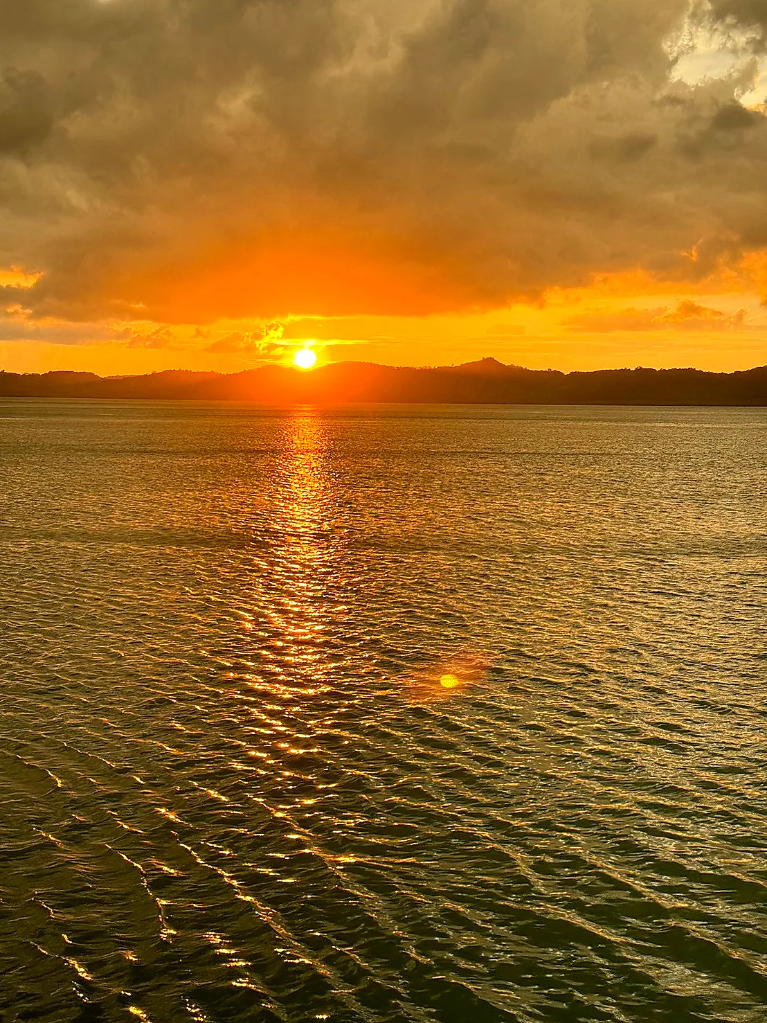 Golden sunset over the sea with a kayak silhouette